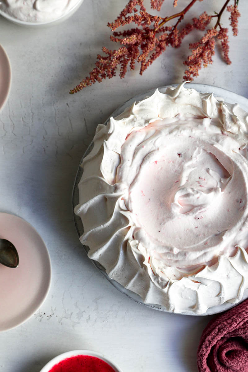 Overhead shot of the meringue base filled with strawberry Chantilly cream