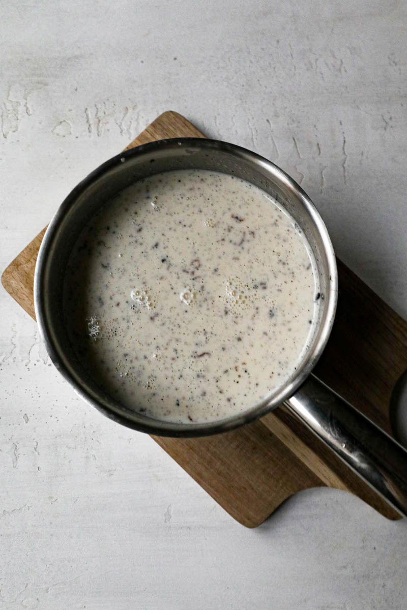 Panna cotta mixture mixed and ready inside a small pot.