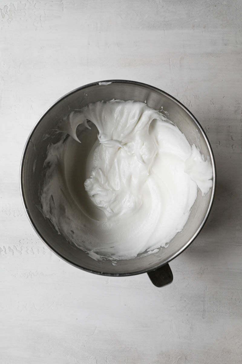 Whisked egg whites inside a mixing bowl.