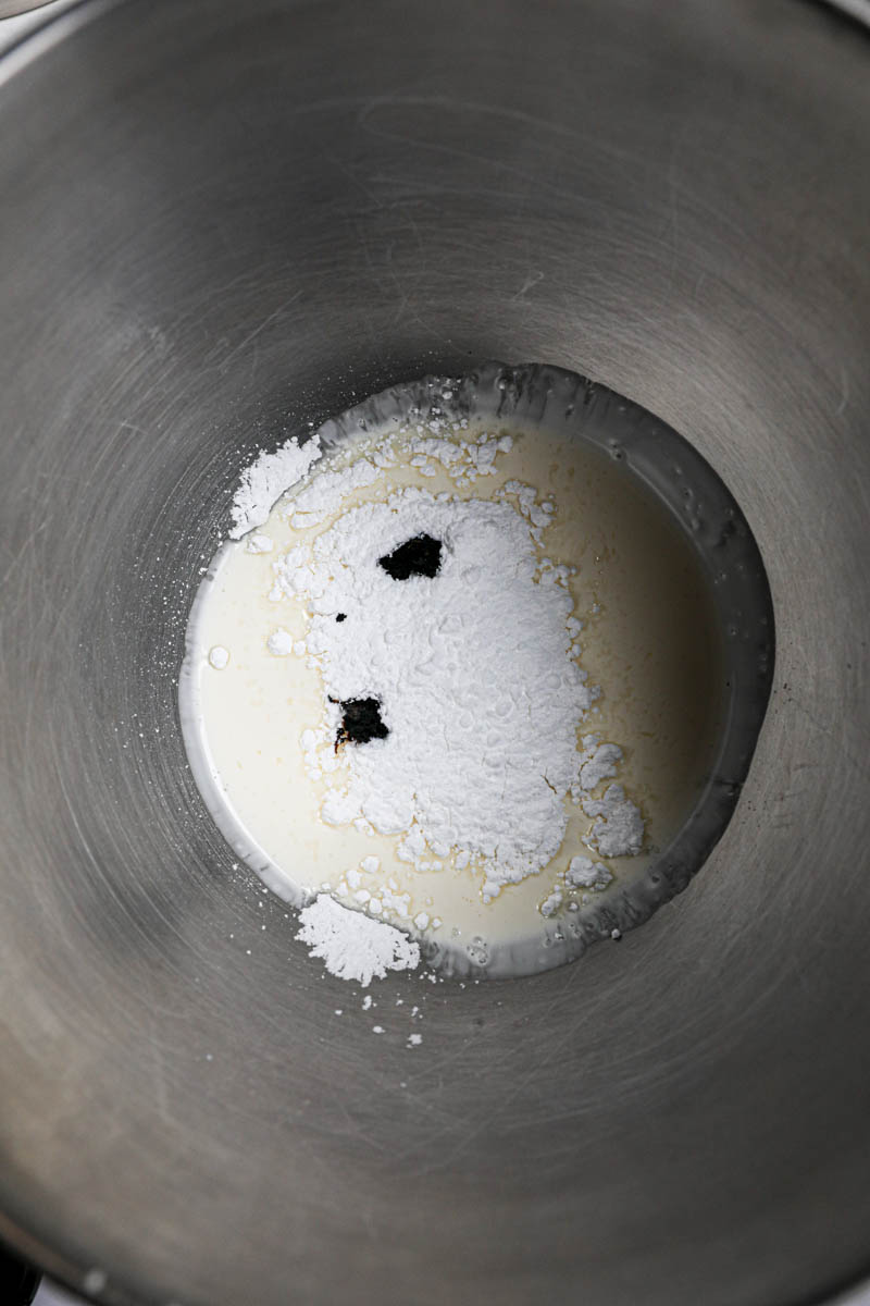 Making Chantilly cream frosting: cream, vanilla sugar in a mixing bowl.