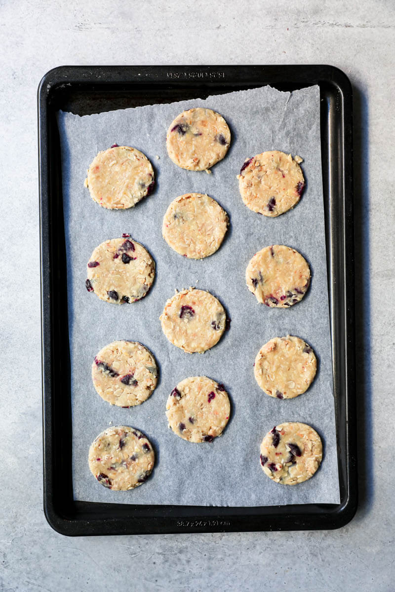 The cranberry oatmeal cookies on a tray lined with parchment paper