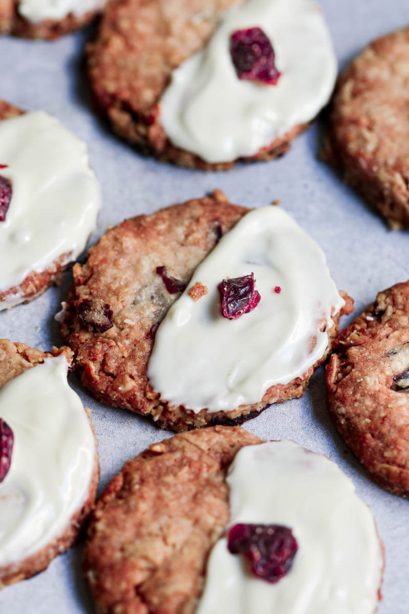 Baked oatmeal cookies frosted with melted white chocolate