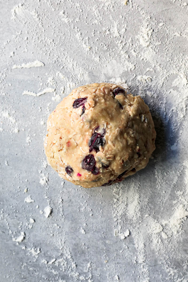 The oatmeal cookie dough on a lightly floured surface in a ball shape