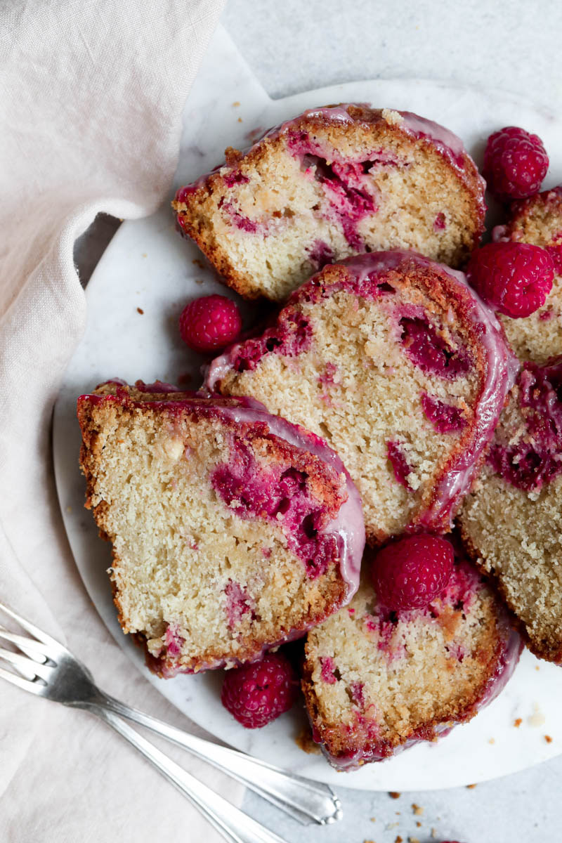 Slices of the Bundt cake on a marble platter with a napkin on the side.