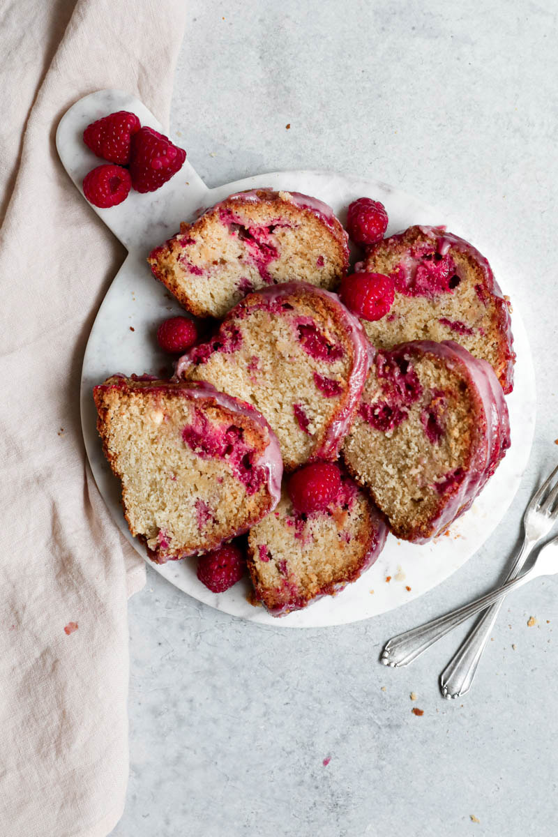 Slices of the Bundt cake on a marble platter with a napkin on the side.