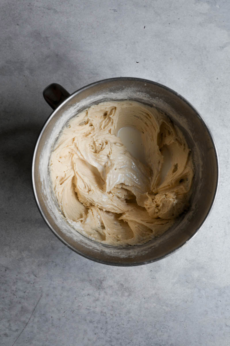 The cake batter in a bowl with the added milk.