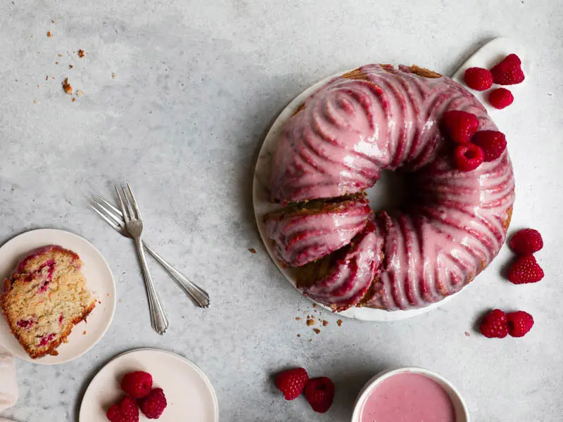 White chocolate raspberry cake with a pink glaze as seen from above.