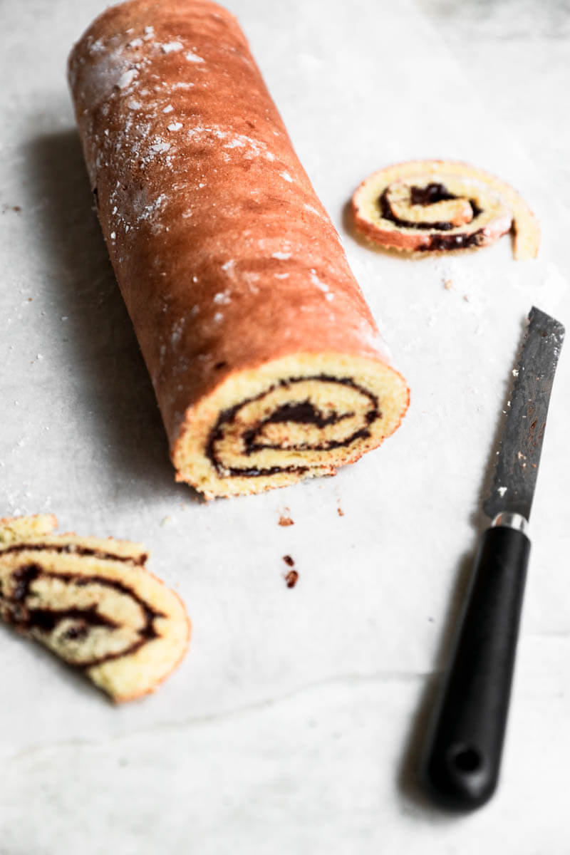 Filled yule log cake with the edges trimmed off