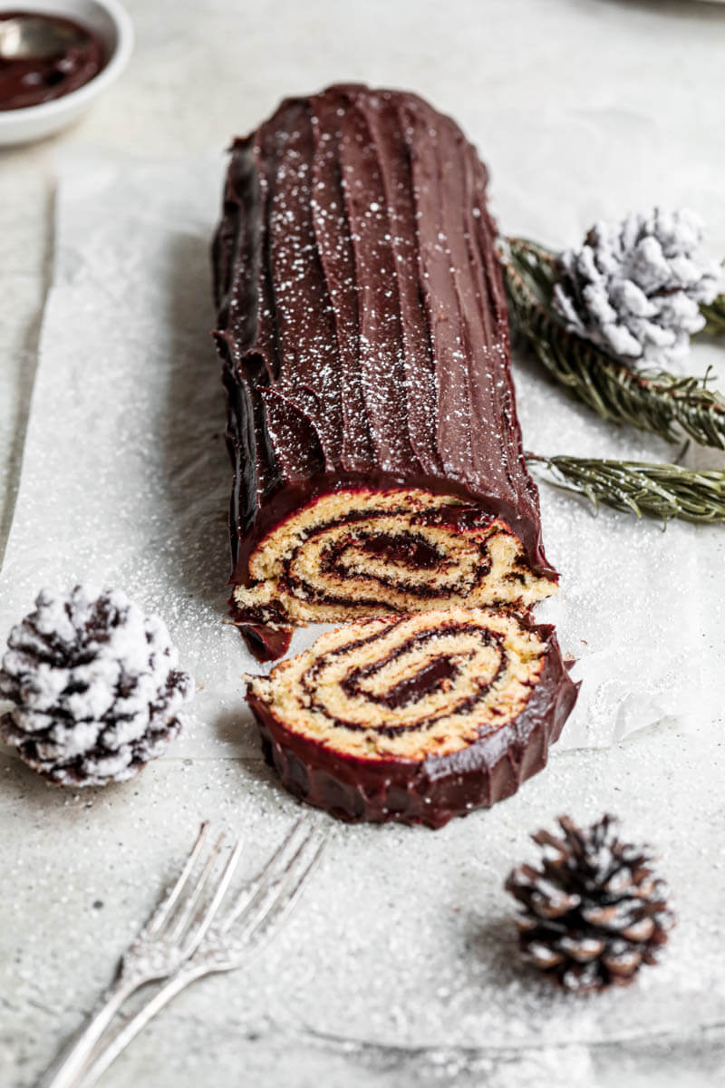 Yule log cake with some pine cones laying around