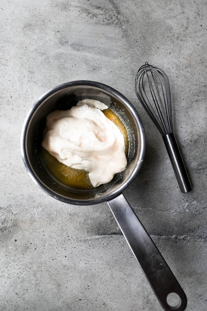 Small pan with the melted butter and some batter